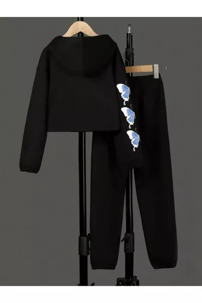 white tracksuit with black child butterfly print