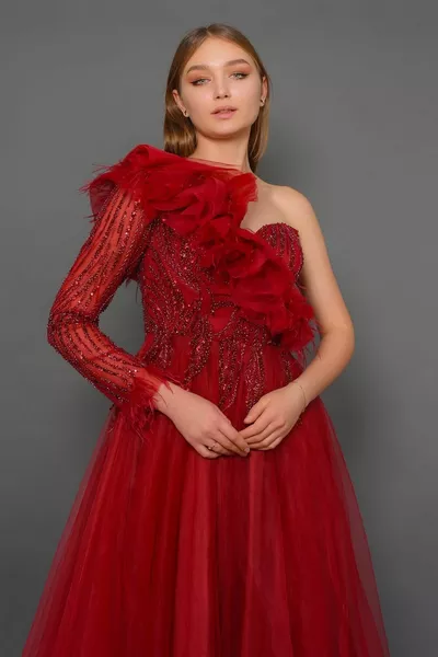 Sequin and bead embroidered one-shoulder evening dress with long sleeves and feather details
