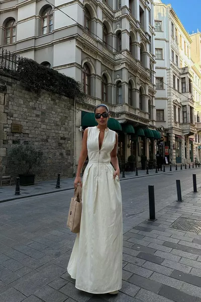 فستان واسع قصّة عند الخصر بتفاصيل سحّاب كبيرة بدون أكمام من قماش الكتان، مشابه على موقع بينتيريست