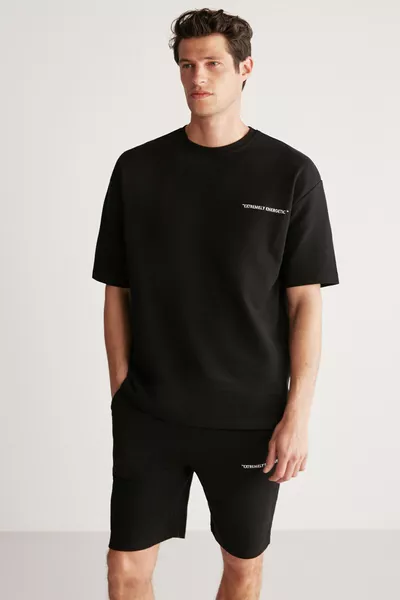 طقم رجالي كولومبيا مكون من قطعتين، قصة مريحة، مطرز بالكتابة، بدون شاردون باللون الأسود