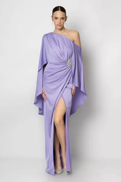 Evening dress with a single sleeve cape with accessories at the waist