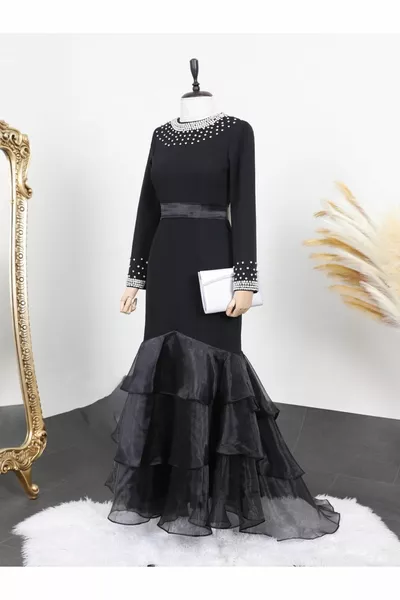 Evening dress with a folded skirt collar and a stone on the sleeve