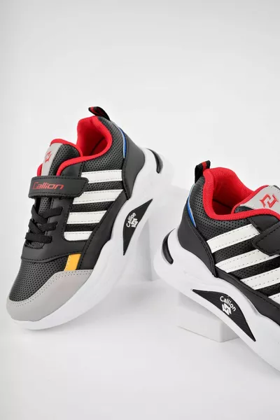 Kinder-Sneaker mit schwarzer bis weißer Sohle und Velcro