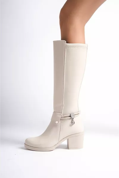 حذاء طويل كريمي بمظهر الجلد، مرن من الخلف، بكعب متوسط إلى عالي، تفاصيل إبزيم وسحاب