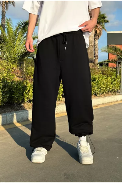 بنطلون رياضي أسود فضفاض بقصة ضيقة عند الكاحل صيفي
