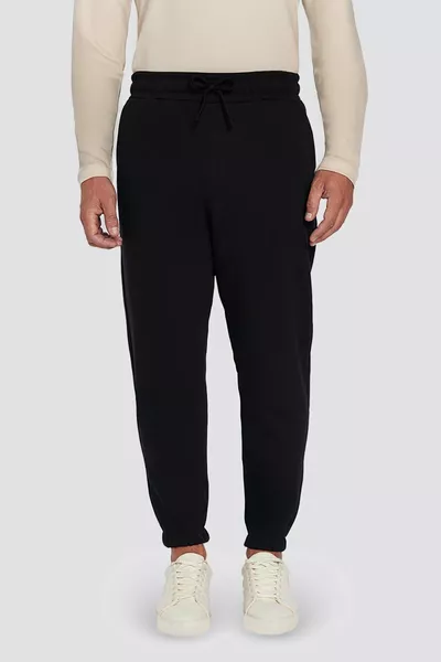 بنطال رياضي أسود مريح للجنسين بقصة فضفاضة، مربوطة الخصر، مزود بثلاث جيوب وطبقة مبطنة