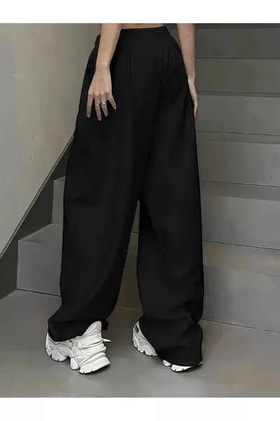 بنطال رياضي نسائي أسود واسع ومرن ومريح من قماش شَاه موضة